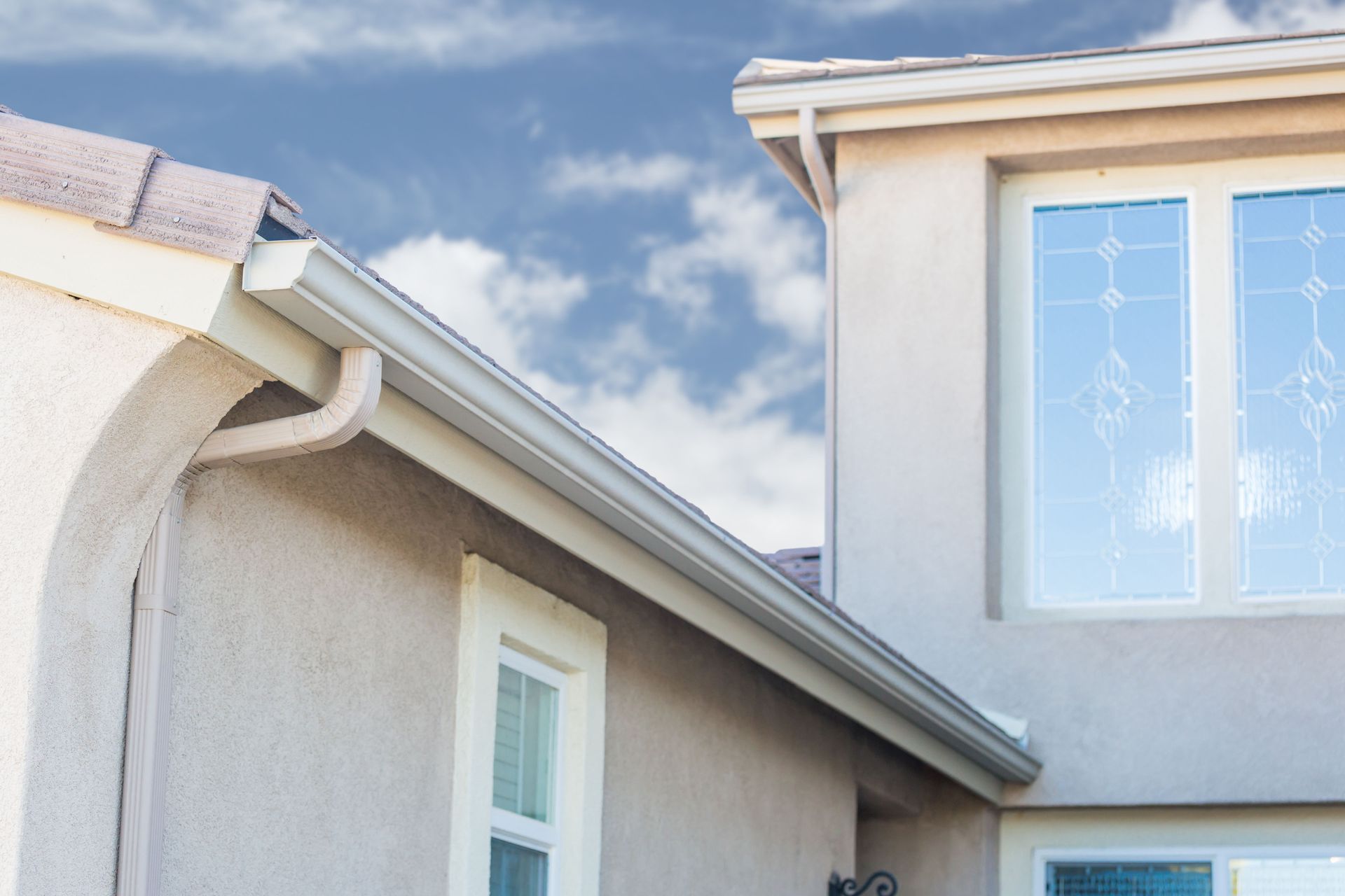 Downspouts on a home serviced by River City Gutters